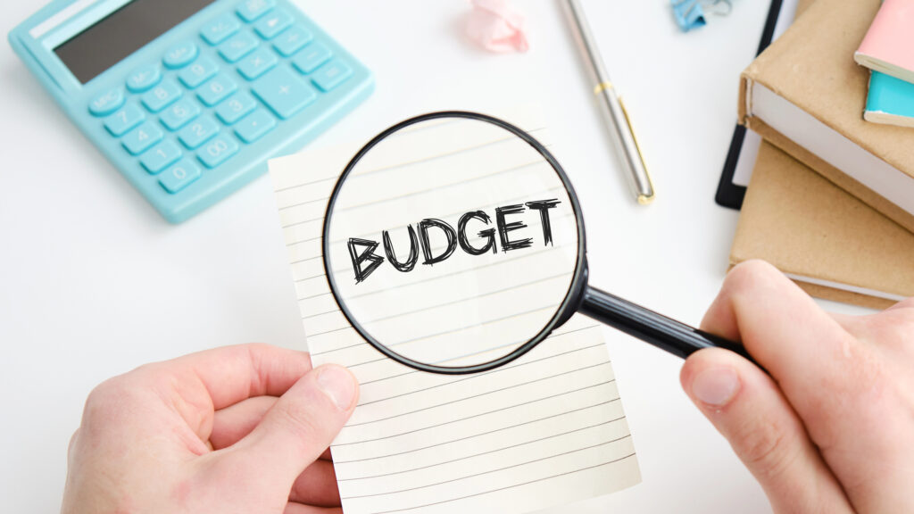Loupe examinant le mot « BUDGET » sur un bloc-notes