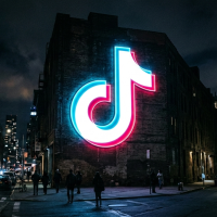 grand logo tiktok lumineux sur un immeuble urbain de nuit.